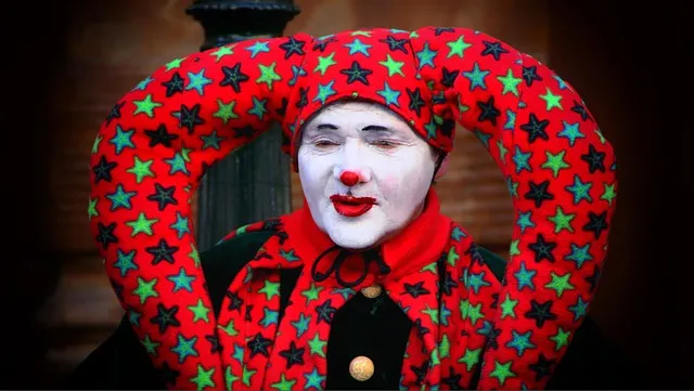 A confused clown stares blankly into the middle distance